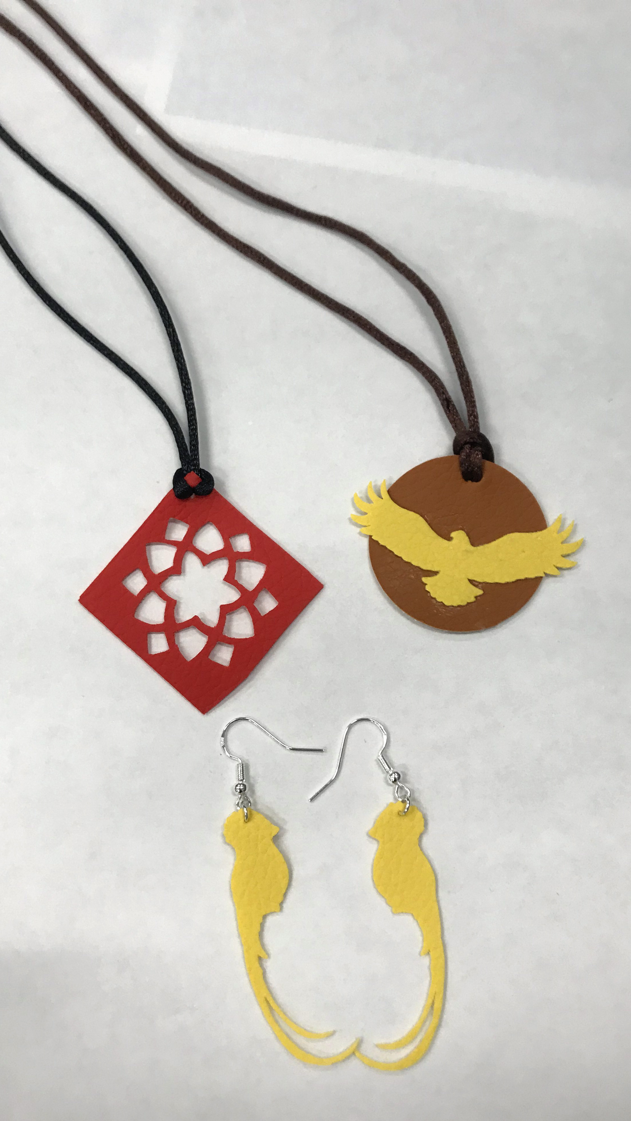 two necklaces and a pair of earrings