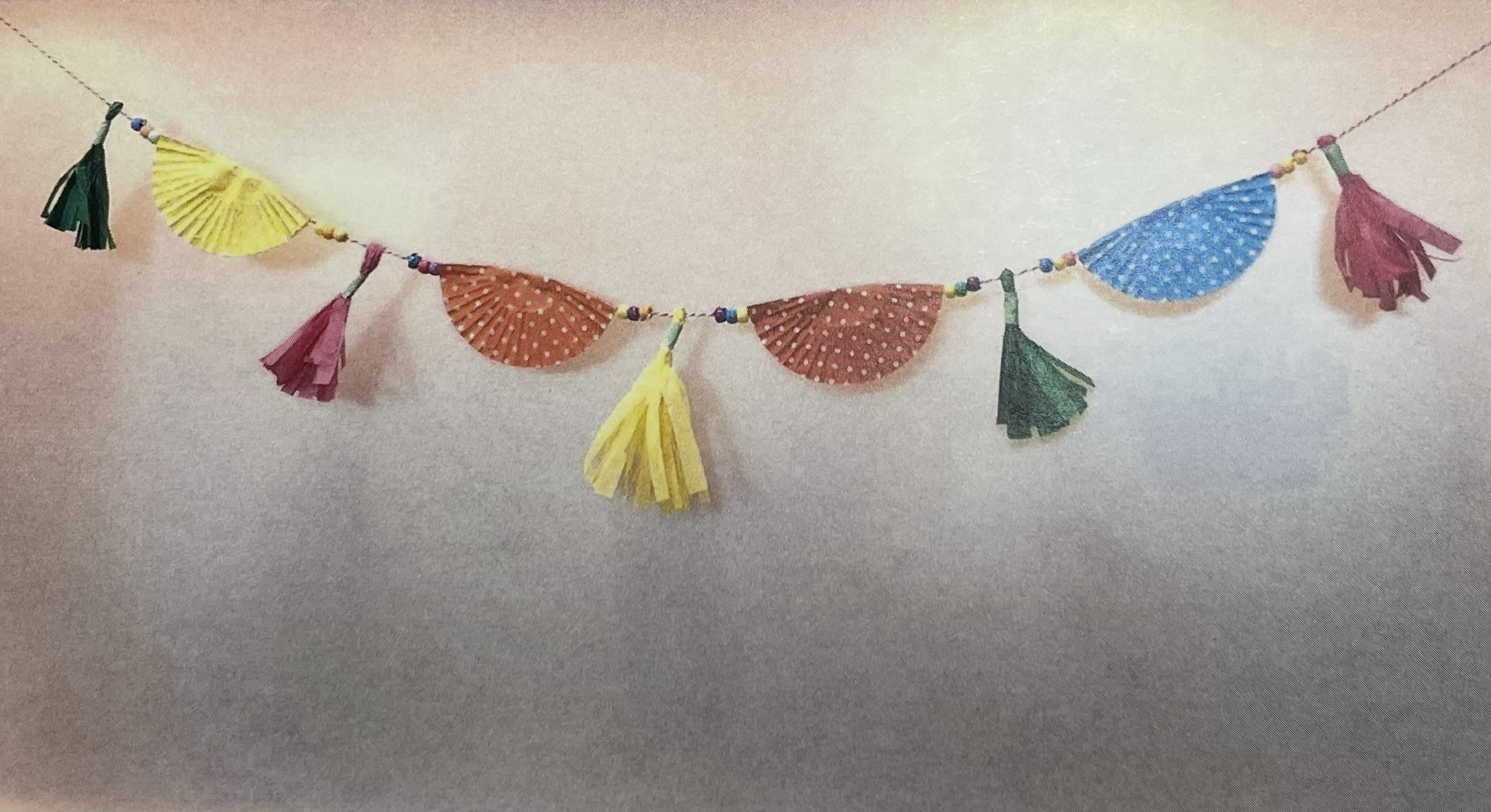party garland with tissue paper tassels and paper cupcake liners