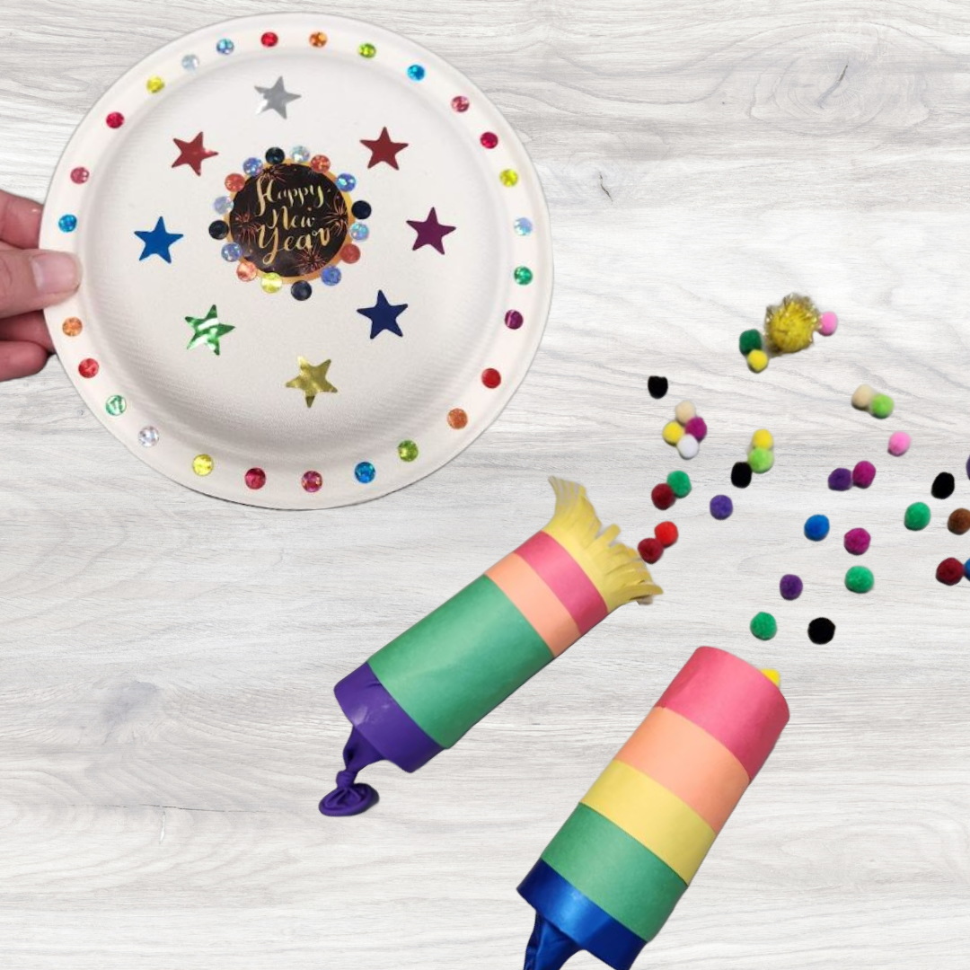 Party tamborine made from paper plates decorated with stickers, two party poppers made from paper roll tubes, colored paper. They appear to spray out colored pom-poms.