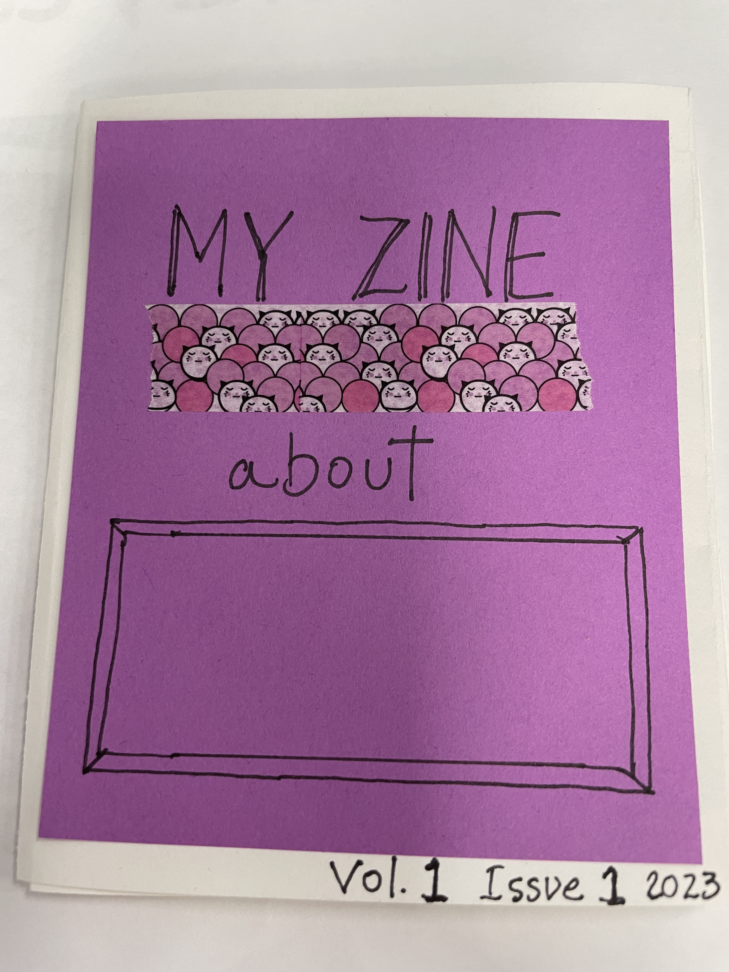 A 'zine' homemade magazine with a purple cover. Text: My zine about _____