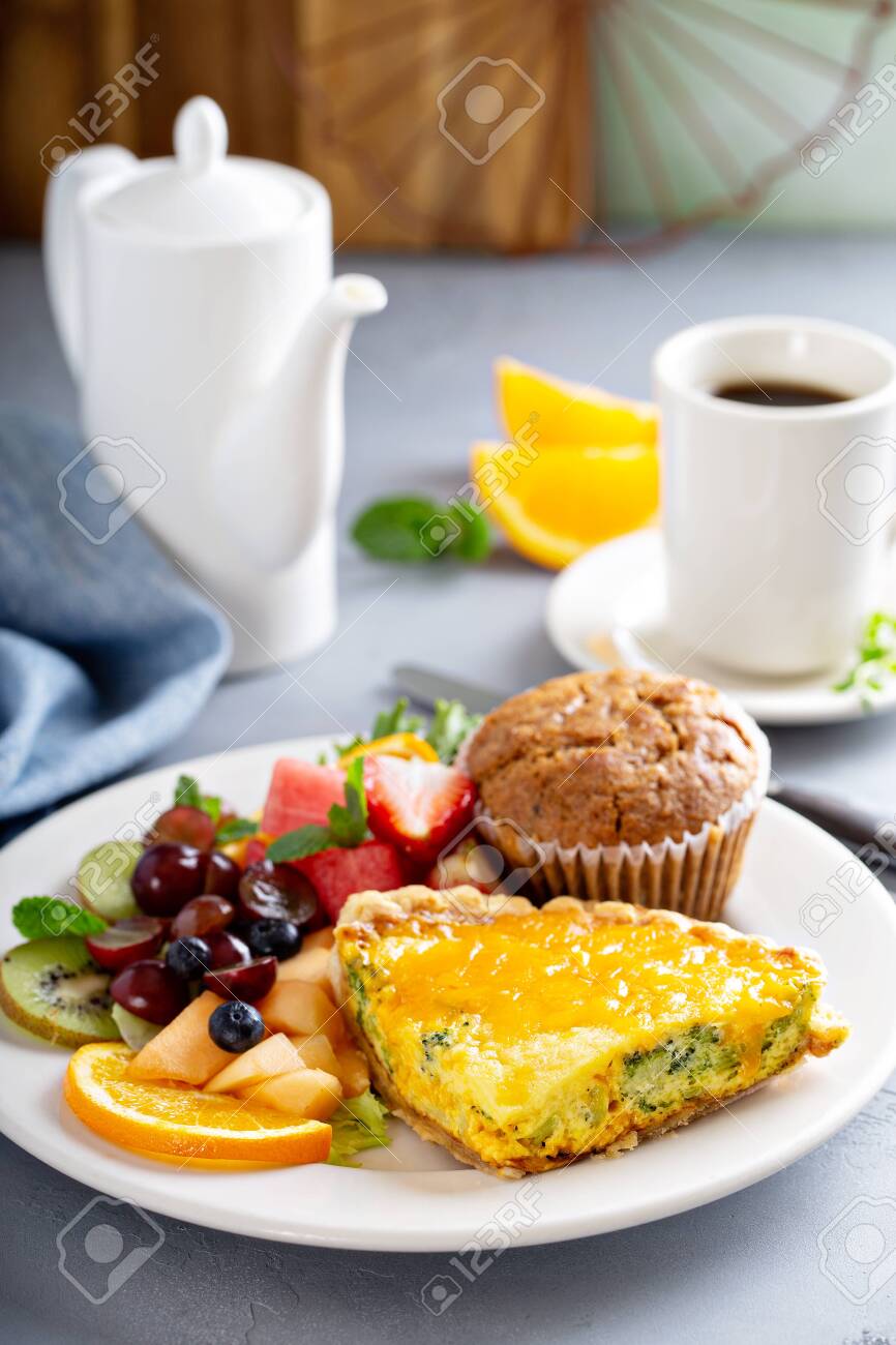 Brunch table with quiche, fruit and muffin