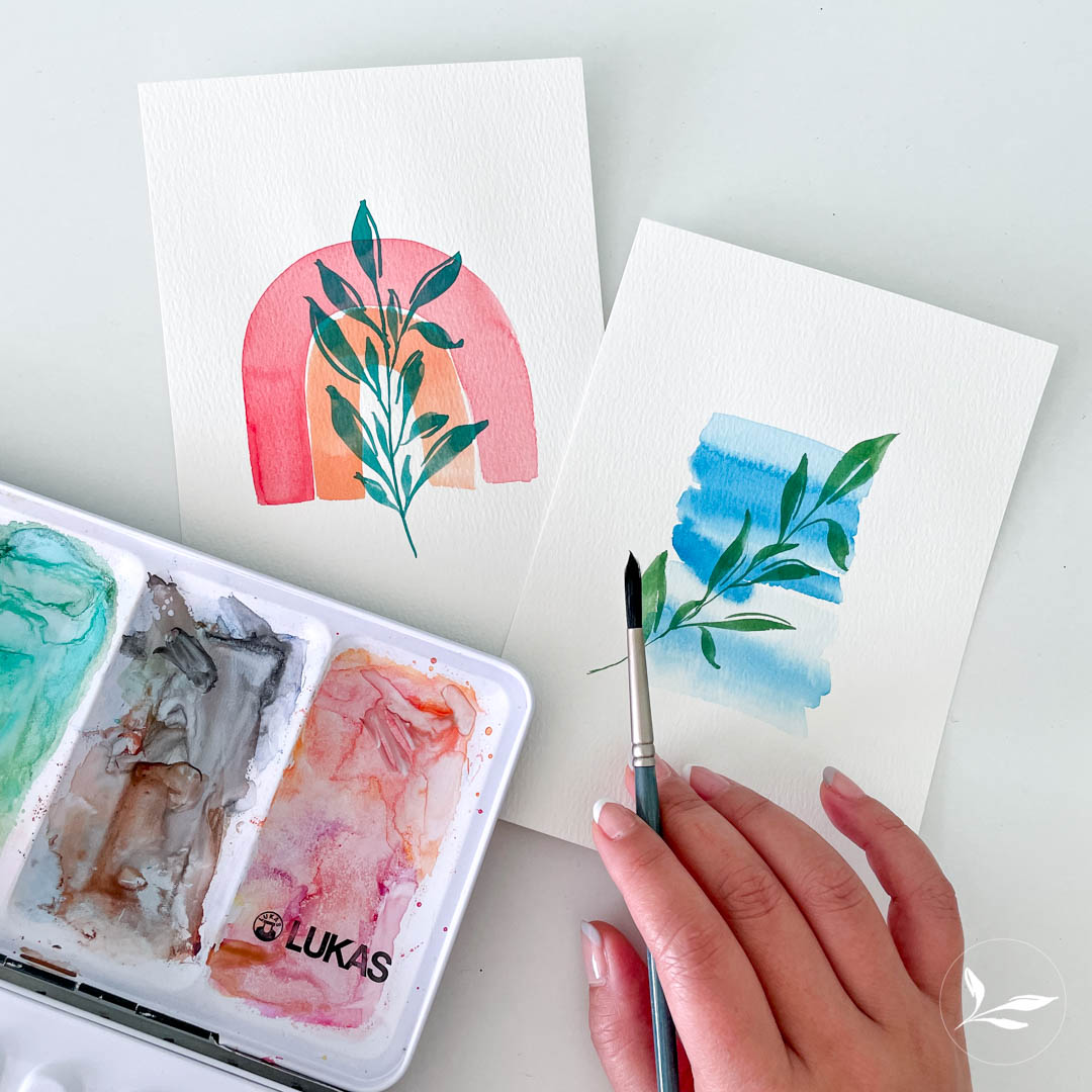 Water color palette and 2 watercolors with of plants with pastel background a