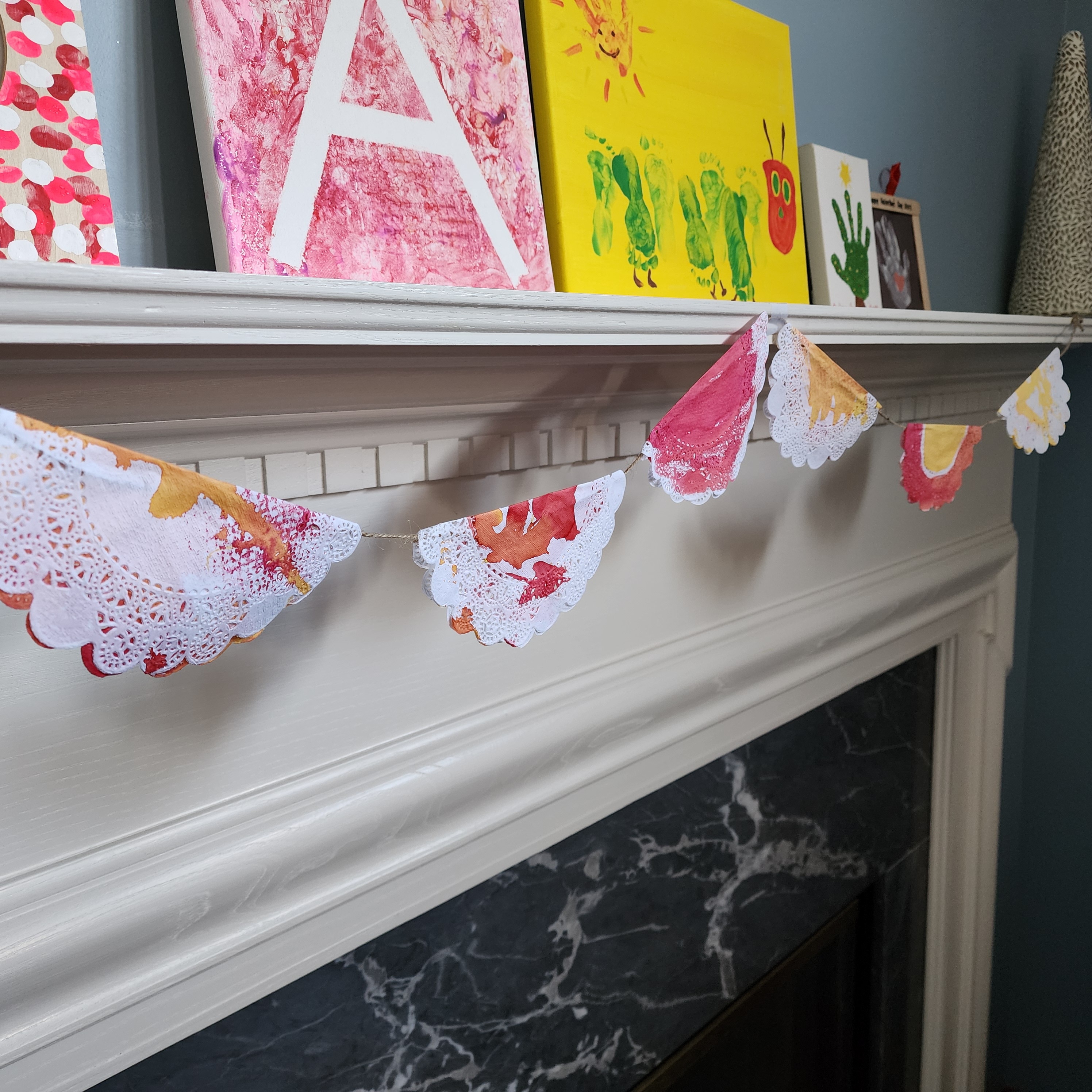 Watercolor stained row of doilies strung up by string
