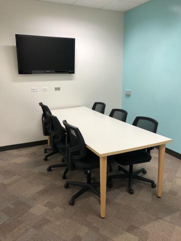 photo of Youth Study Room shows a table with six rolling chairs. On the wall, a large television is seen with electronic inputs beneath it.