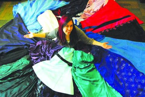 Librarian Sarah Okner surrounded by prom dresses