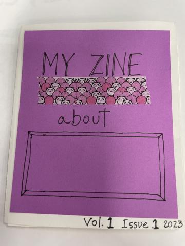 A 'zine' homemade magazine with a purple cover. Text: My zine about _____