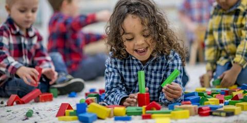 Young girl playing with colorful blocks