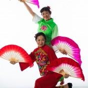 dancers in traditional Chinese dress with large silk fans