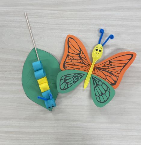 Blue and yellow paper caterpillar on paper leaf orange & green butterfly