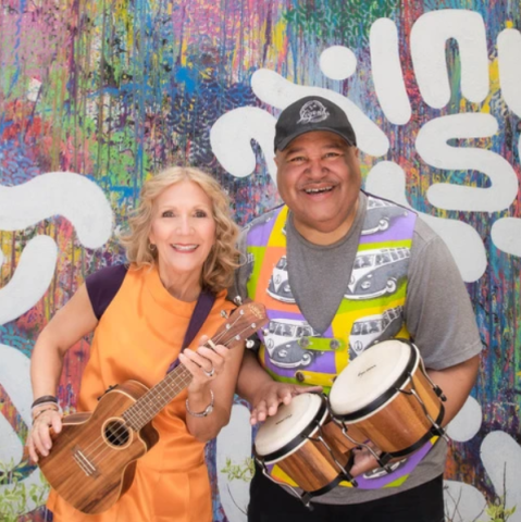 Wendy, a blonde woman with a ukulele, and DB, a Black man with bongos, in front of a fun graffiti background