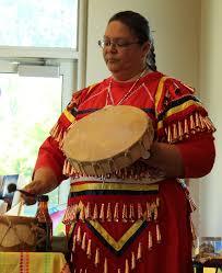 Woman in traditional dress holding drum