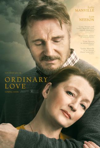 Film poster for Ordinary Love. Against a backdrop of clouds, a man with gray hair and facial hair wraps his arms around a woman with brown hair. 