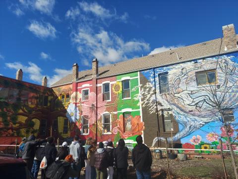 Mural of colorful flowers on the side of a building