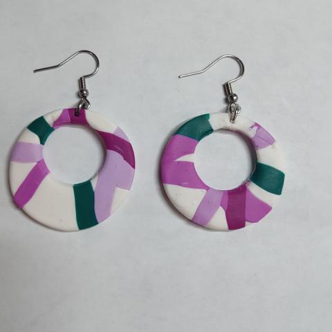 White dangle earrings shaped into circles with dashes of pink and green