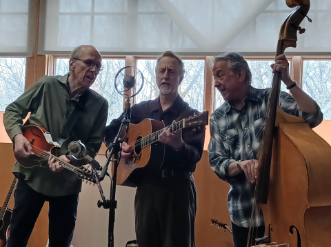 Musicians playing guitar, bass, and mandolin
