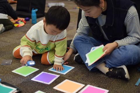 Parent and child playing with Sphero Indi coding car