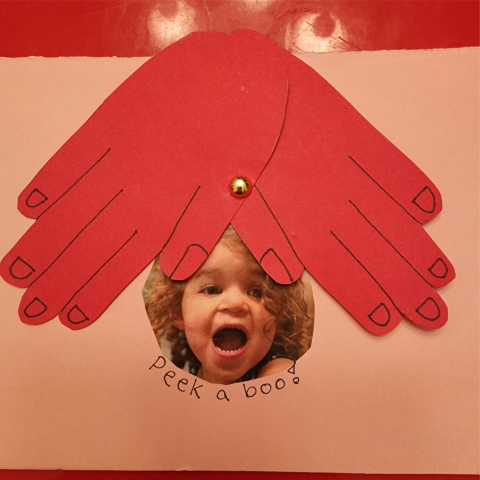 Picture of toddler is positioned between two overlapping red hands