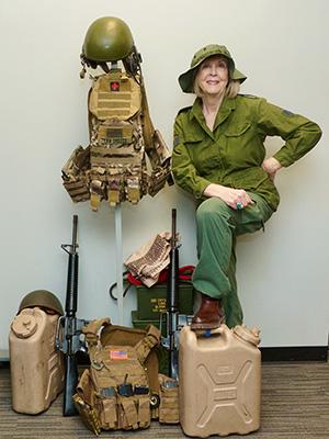 Lynn Rymarz with artifacts from Vietnam