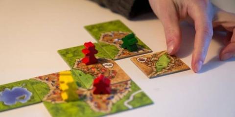 Person playing board game, Carcassonne