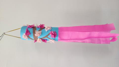 blue paper windsock with pink paper cherry blossoms with pink paper streamers