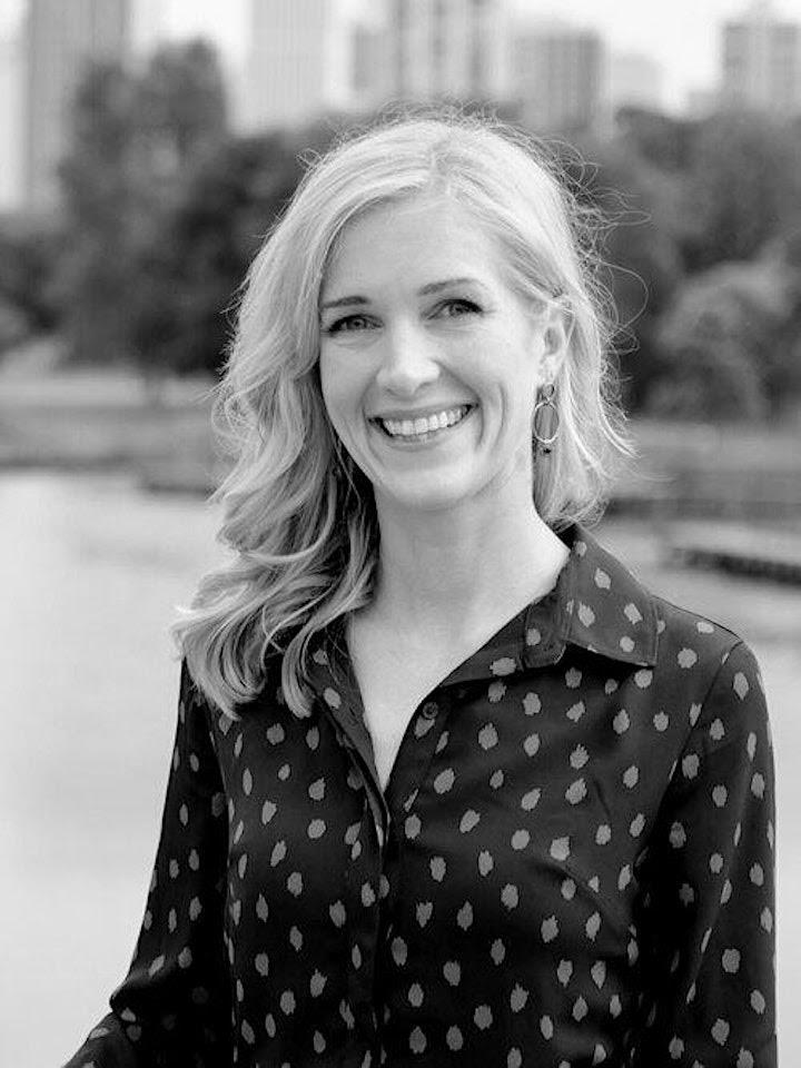 Black and white photo of Dr Caroline Adelman in a dark blouse