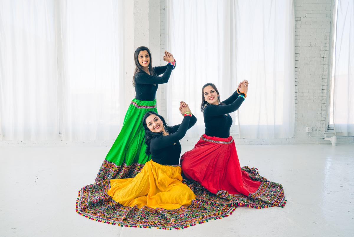 3 women in traditional Indian dance costumes