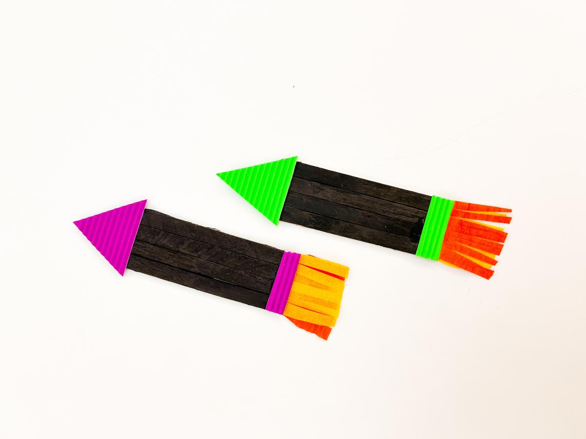 Colorful firework rocket crafts made out of popsicle sticks and paper