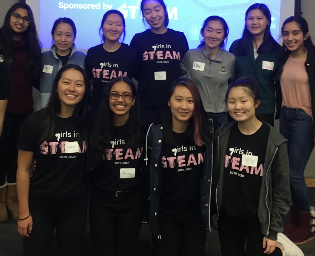 Group of young women in black t-shirts with Girls in STEAM logo