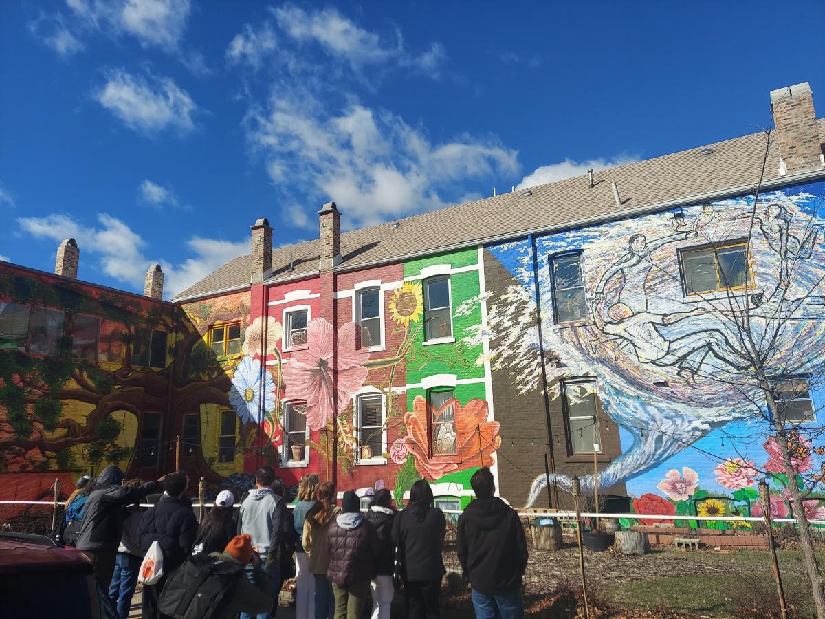 Mural of colorful flowers on the side of a building