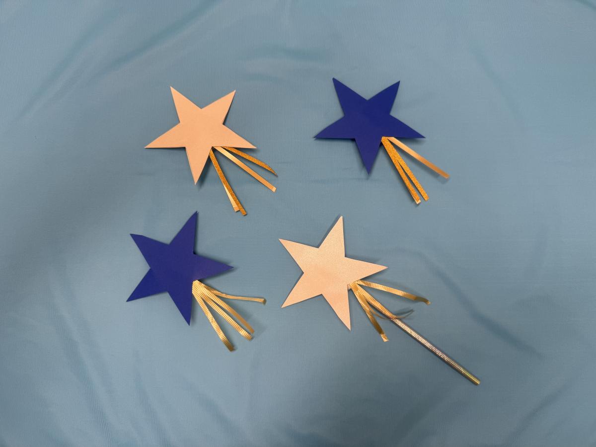 Blue and gold stars connected to a straw