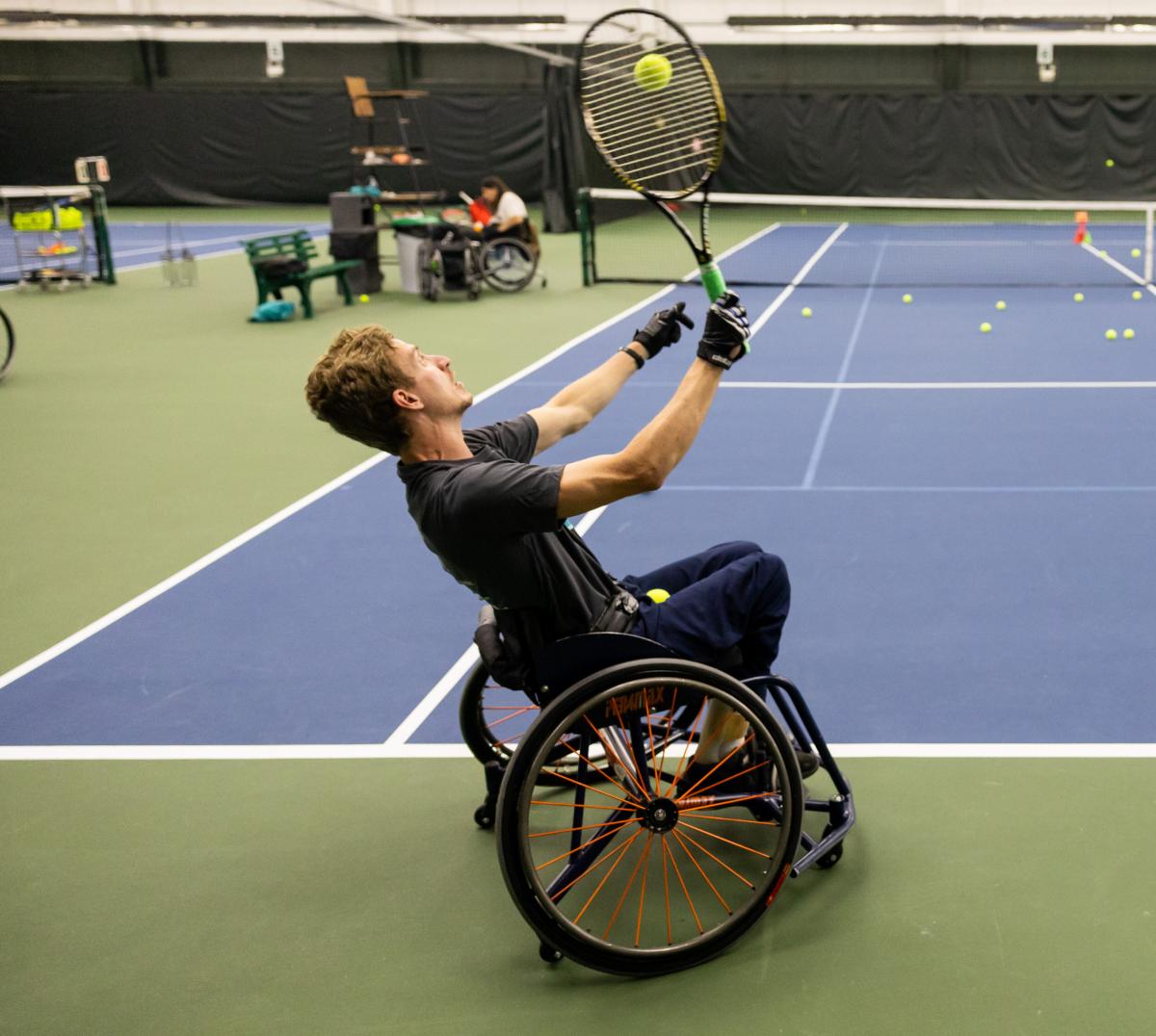 Man playing tennis in wheelchair